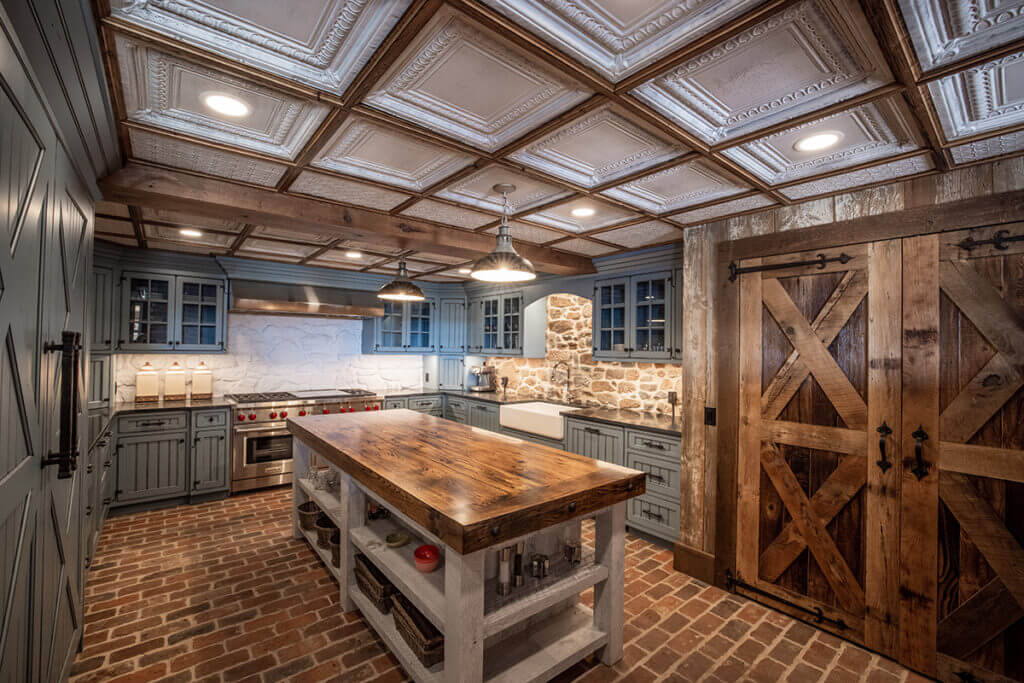 Cottagecore interior design kitchen with blue cabinets and a wooden island